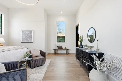 a roof deck with table and chairs a barbeque with wooden floor and city view