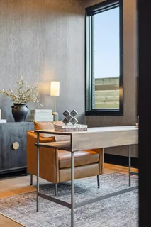 a living room with furniture a lamp and potted plant