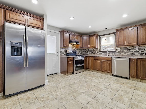 65 Gore Road Revere, MA 02151 - Photo 11 of 35 a kitchen with stainless steel appliances granite countertop a stove top oven sink and refrigerator