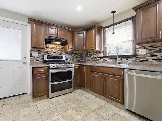 65 Gore Road Revere, MA 02151 - Photo 13 of 35 a kitchen with stainless steel appliances granite countertop a stove sink and microwave