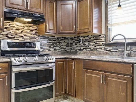 65 Gore Road Revere, MA 02151 - Photo 14 of 35 a kitchen with granite countertop cabinets stainless steel appliances and a sink