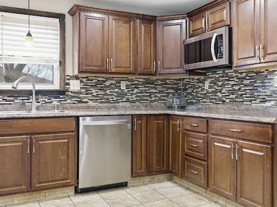 65 Gore Road Revere, MA 02151 - Photo 15 of 35 a kitchen with granite countertop cabinets stainless steel appliances and a window