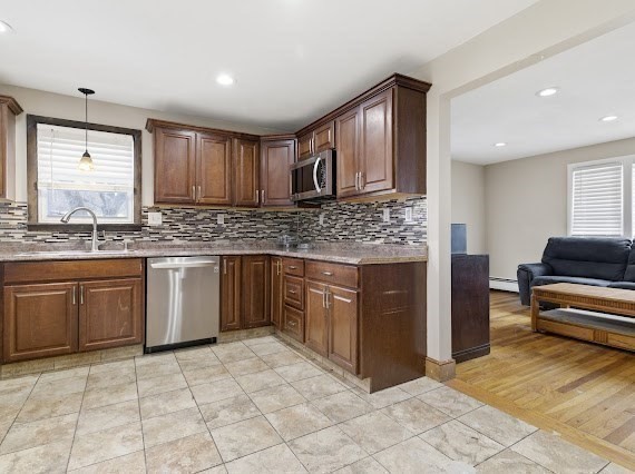 65 Gore Road Revere, MA 02151 - Photo 16 of 35 a kitchen with stainless steel appliances granite countertop a stove sink and cabinets