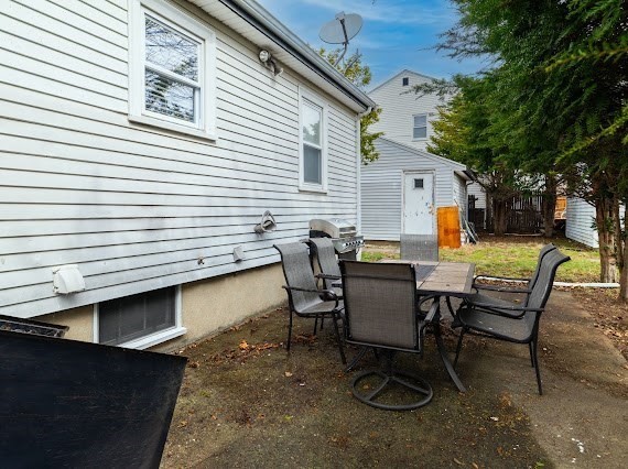 65 Gore Road Revere, MA 02151 - Photo 4 of 35 a view of a yard with a patio and a fire pit