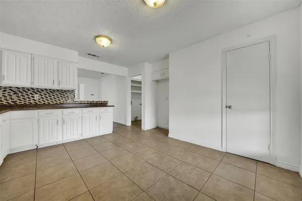 a view of a kitchen with cabinets