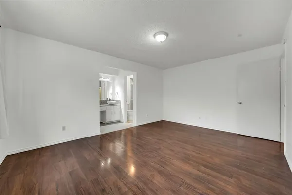 a view of an empty room and wooden floor