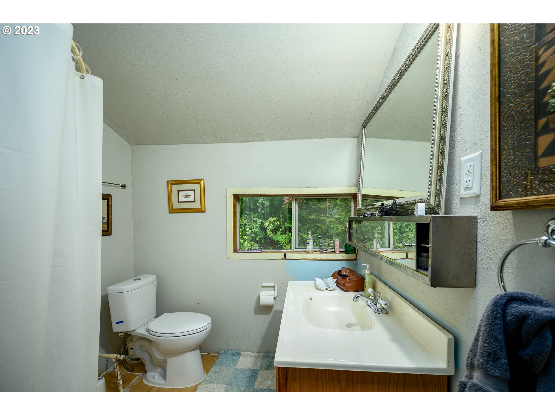 7260 Ash Street Grand Ronde, OR 97347 - Photo 34 of 39 a bathroom with a toilet sink and mirror