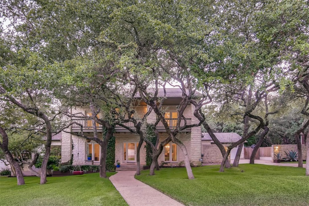 10077 Circleview Drive Austin, TX 78733 - Photo 1 of 1 front view of a house with a tree and a yard