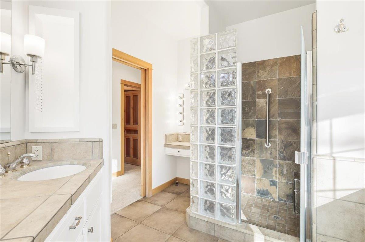 12531 Lowhills Road Nevada City, CA 95959 - Photo 39 of 92 a bathroom with a granite countertop sink a mirror and shower