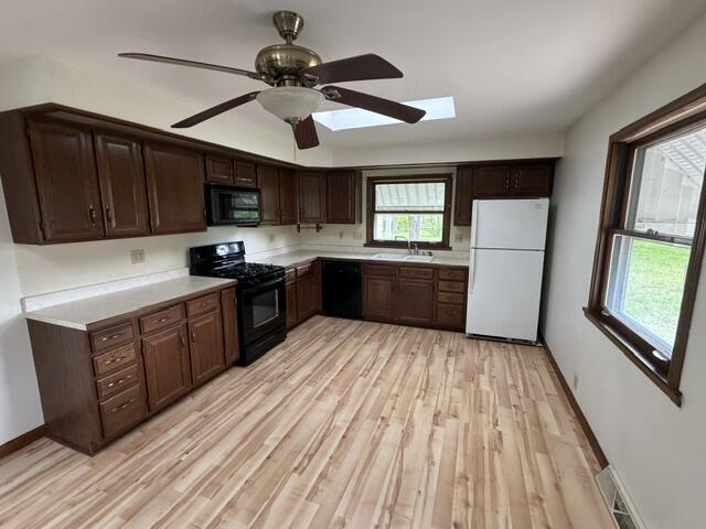 1001 Earl Road Michigan City, IN 46360 - Photo 12 of 24 a kitchen with stainless steel appliances a sink cabinets and wooden floor