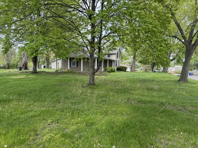 1001 Earl Road Michigan City, IN 46360 - Photo 4 of 24 a front view of a house with a garden