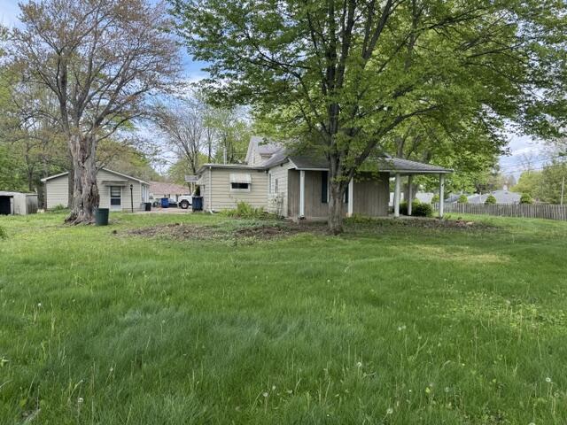 1001 Earl Road Michigan City, IN 46360 - Photo 7 of 24 a front view of a house with a garden