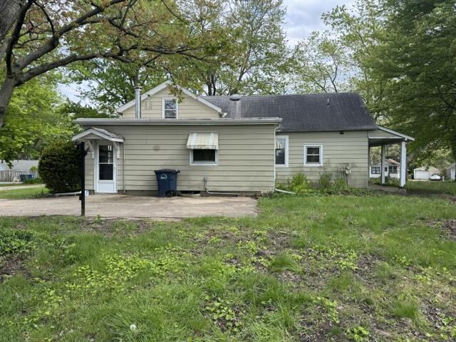 1001 Earl Road Michigan City, IN 46360 - Photo 8 of 24 a front view of a house with a garden
