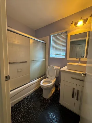 a bathroom with a toilet a sink and shower