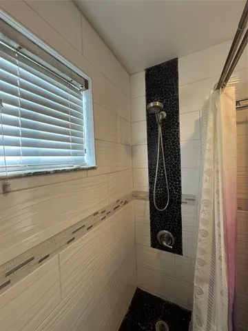 a bathroom with a shower and a sink