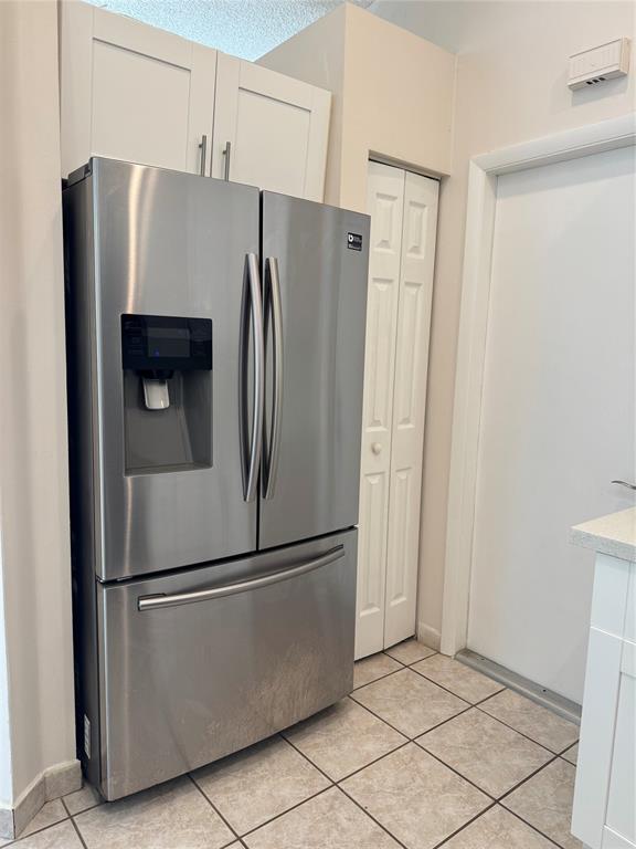 4077 Pine Ridge Lane Weston, FL 33331 - Photo 23 of 25 a metallic refrigerator freezer sitting in a kitchen