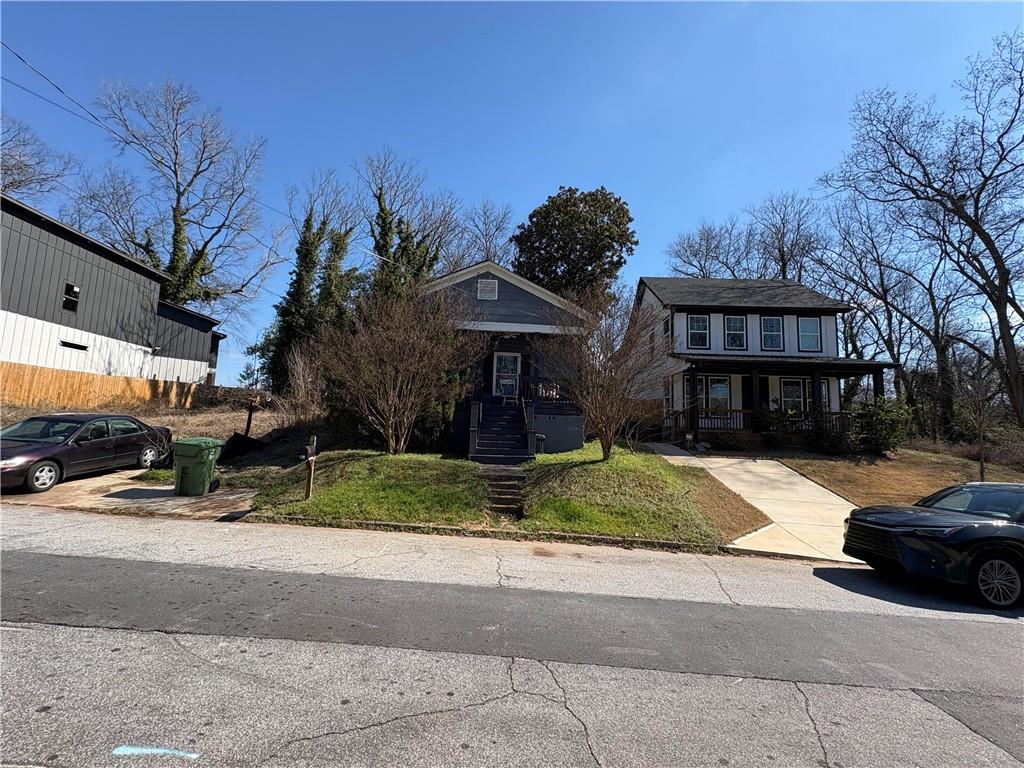 1154 Welch Street Southwest Atlanta, GA 30310 - Photo 6 of 7 a front view of a house with a yard and garage