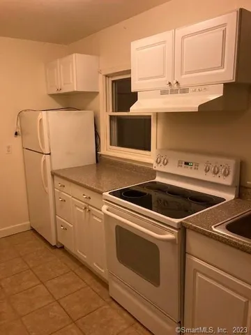 a kitchen with cabinets and appliances