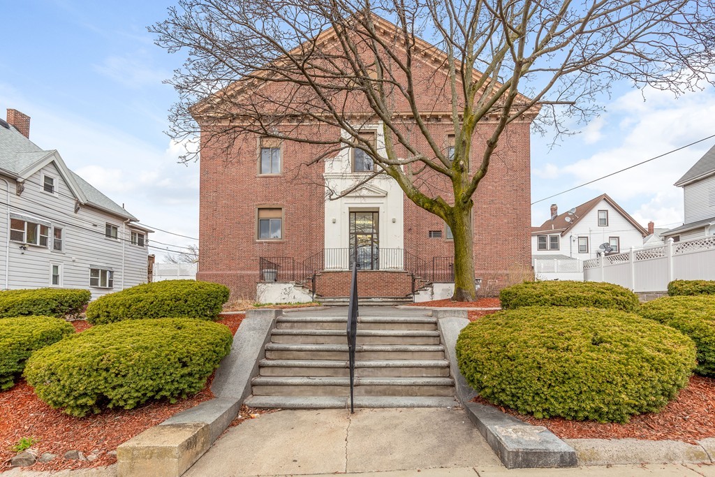 a front view of a house with garden