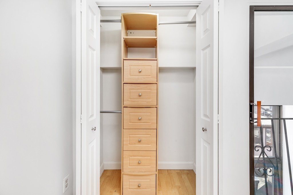 12 Locust Street, Unit 3D Everett, MA 02149 - Photo 17 of 24 a view of walk in closet with clothes