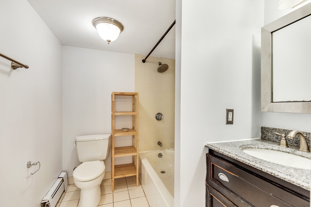 12 Locust Street, Unit 3D Everett, MA 02149 - Photo 18 of 24 a bathroom with a granite countertop sink toilet and shower