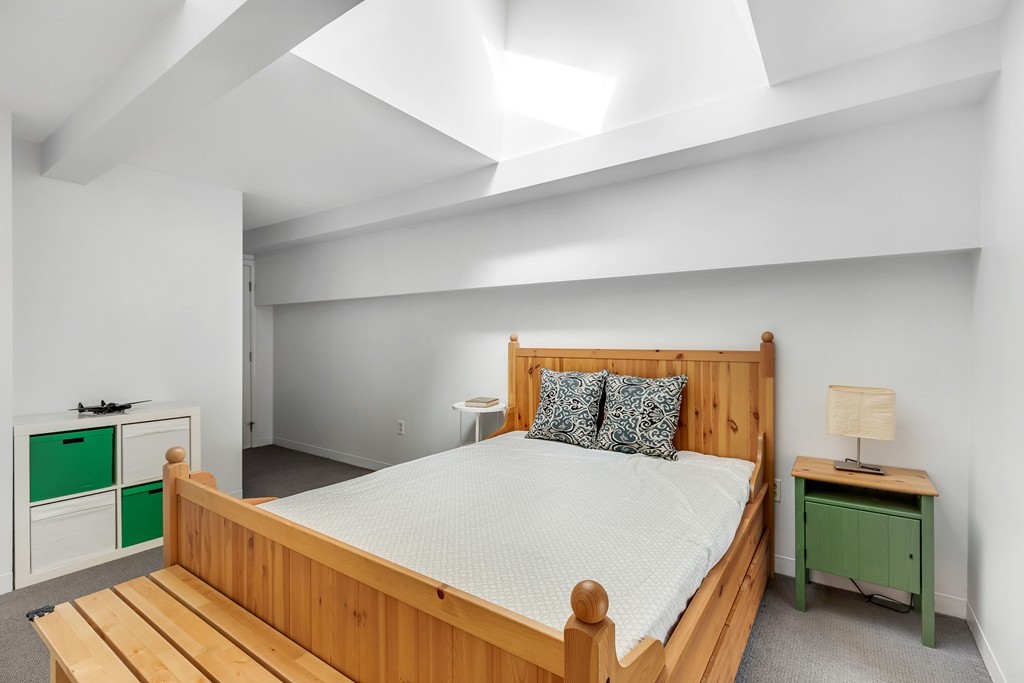 12 Locust Street, Unit 3D Everett, MA 02149 - Photo 20 of 24 a bedroom with a bed and a dresser