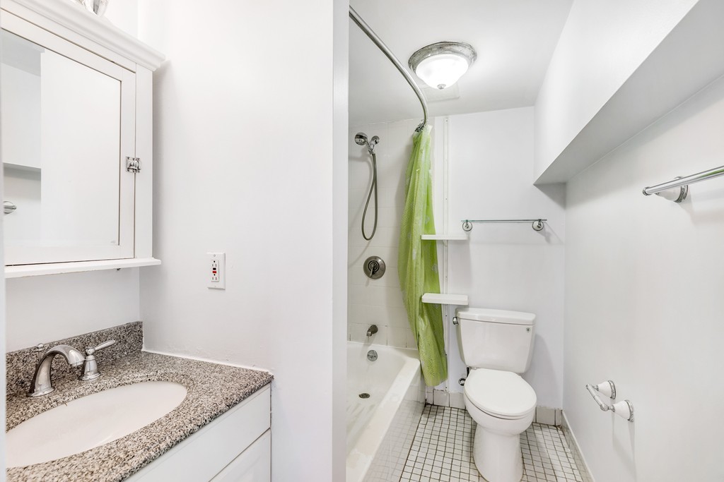 12 Locust Street, Unit 3D Everett, MA 02149 - Photo 22 of 24 a bathroom with a granite countertop toilet sink and shower