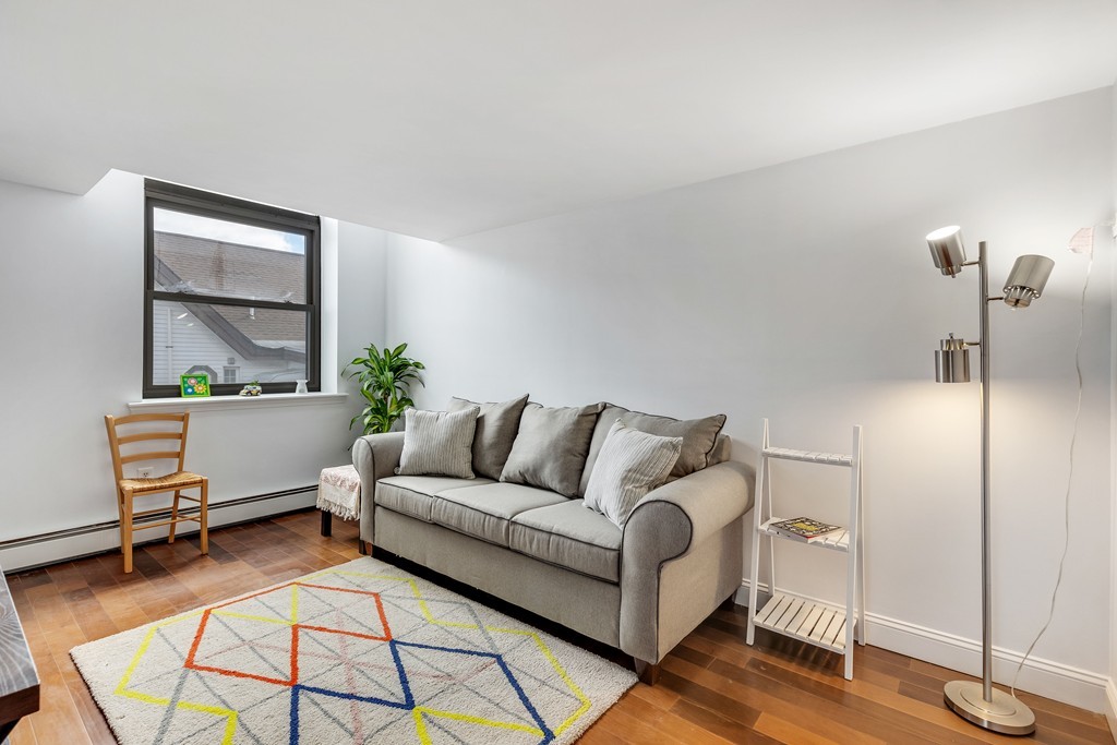 12 Locust Street, Unit 3D Everett, MA 02149 - Photo 5 of 24 a living room with furniture and a table