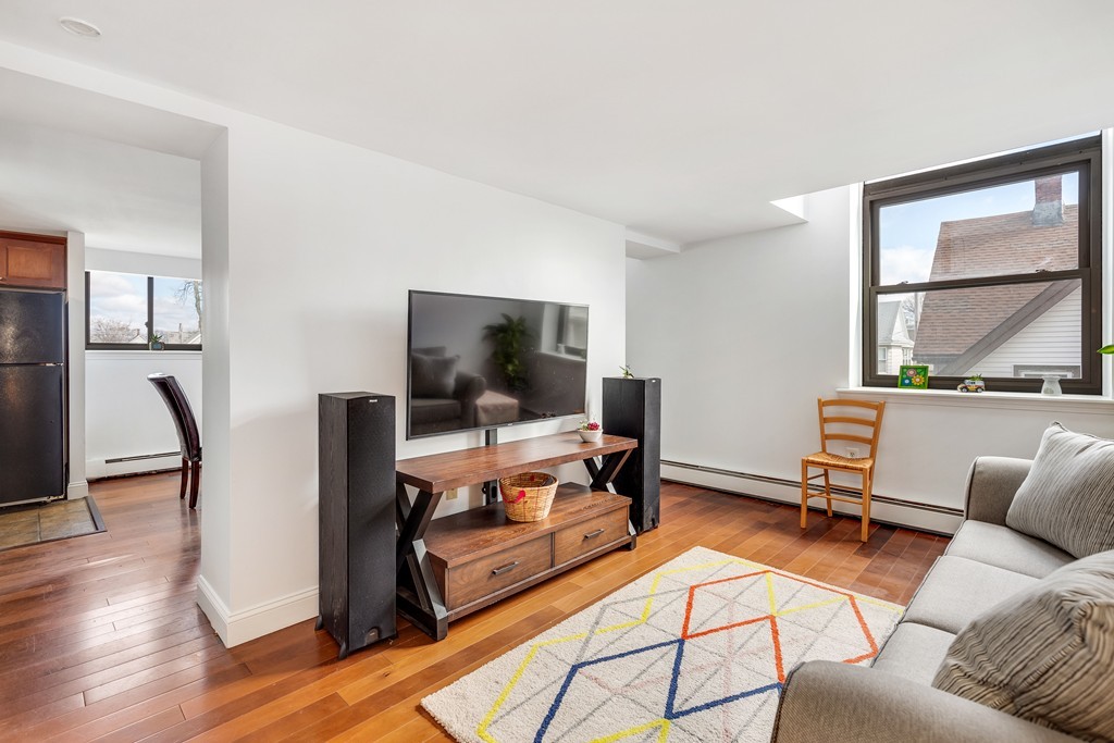 12 Locust Street, Unit 3D Everett, MA 02149 - Photo 6 of 24 a living room with furniture and a flat screen tv