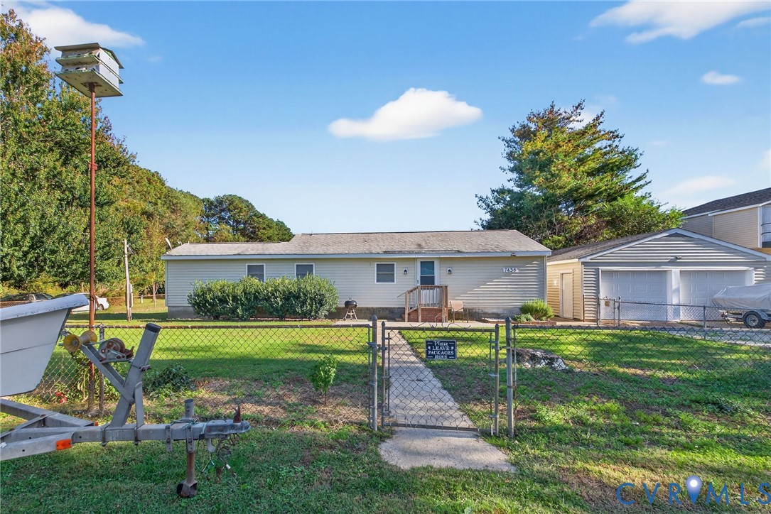 7436 Richmond Road Williamsburg, VA 23188 - Photo 16 of 44 a view of a house with a yard and a patio
