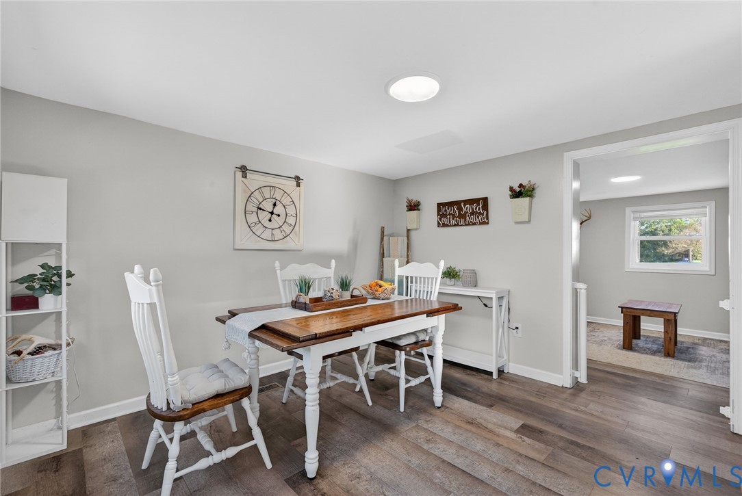 7436 Richmond Road Williamsburg, VA 23188 - Photo 5 of 44 a view of a dining room with furniture and wooden floor