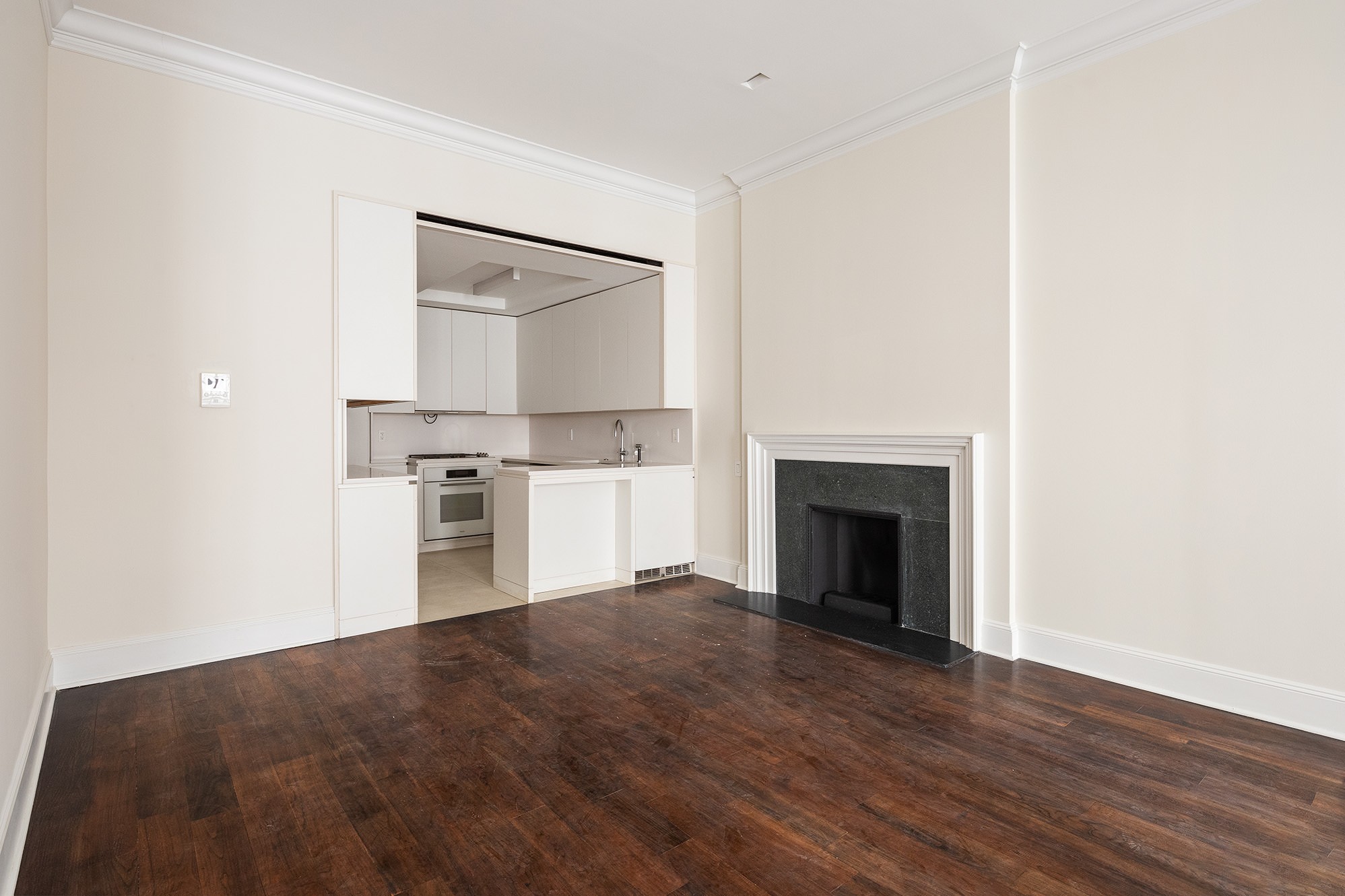 127 East 69th Street, Unit RES 3 Manhattan, NY 10021 - Photo 3 of 10 a view of a kitchen with a sink cabinets and a fireplace