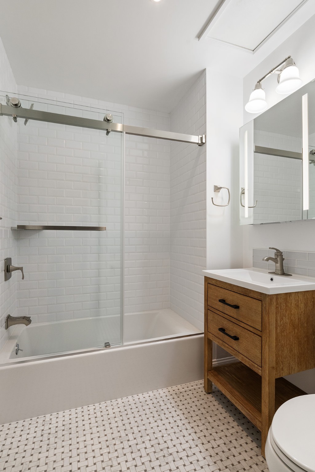 127 East 69th Street, Unit RES 3 Manhattan, NY 10021 - Photo 8 of 10 a bathroom with a bathtub a sink and a shower