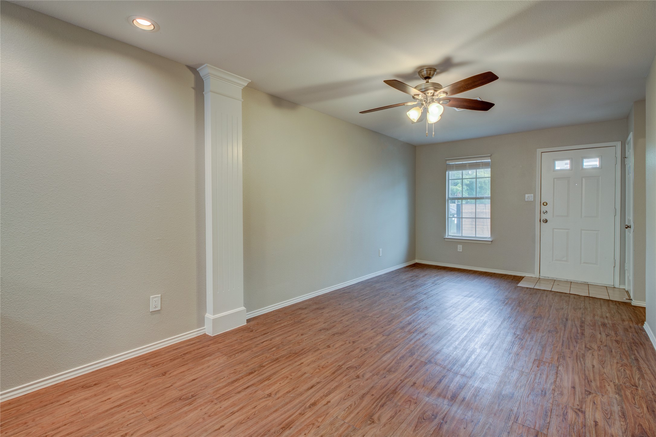 202 South College Street, Unit 9 Georgetown, TX 78626 - Photo 12 of 22 a view of an empty room with wooden floor and a window