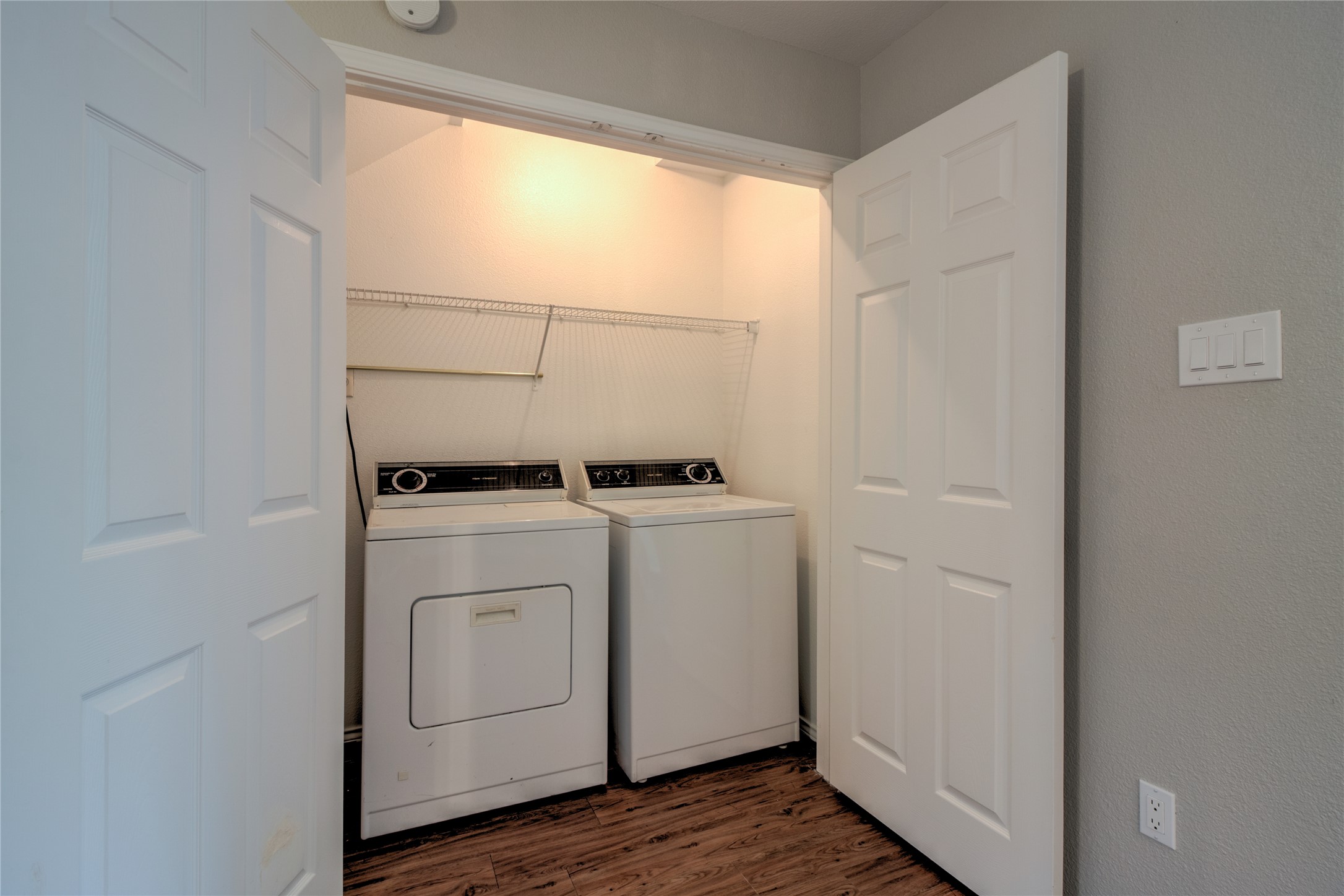 202 South College Street, Unit 9 Georgetown, TX 78626 - Photo 19 of 22 a view of washer and dryer with wooden floor