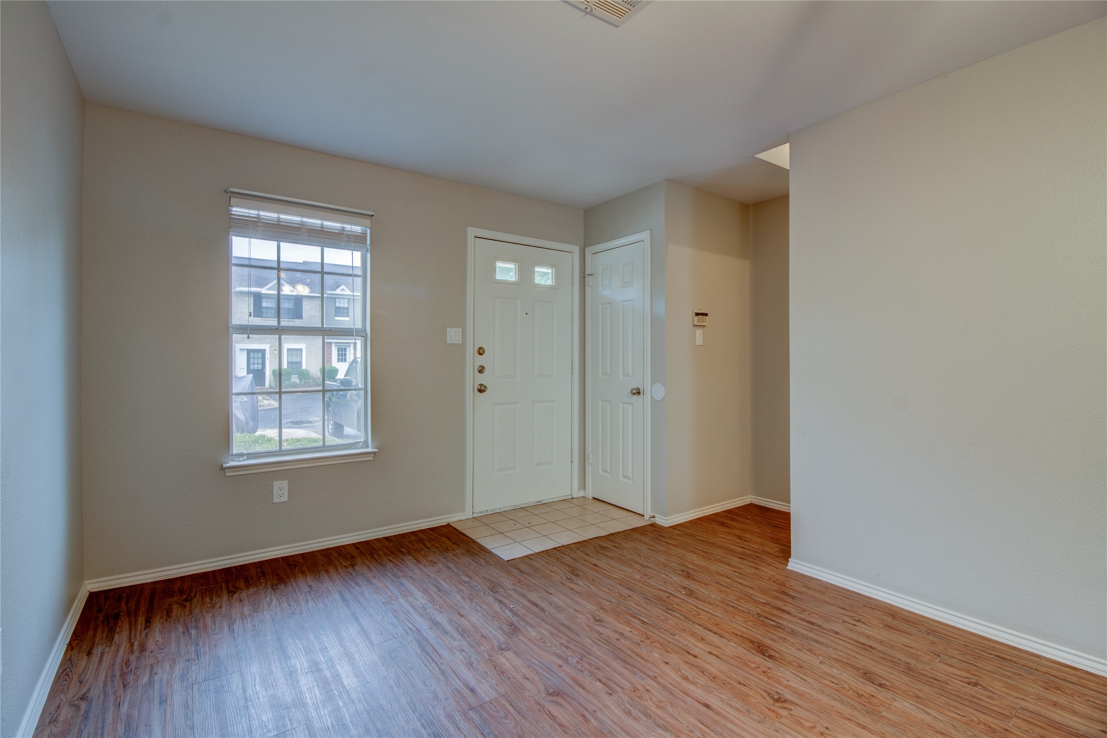 202 South College Street, Unit 9 Georgetown, TX 78626 - Photo 6 of 22 a view of an empty room with wooden floor and a window