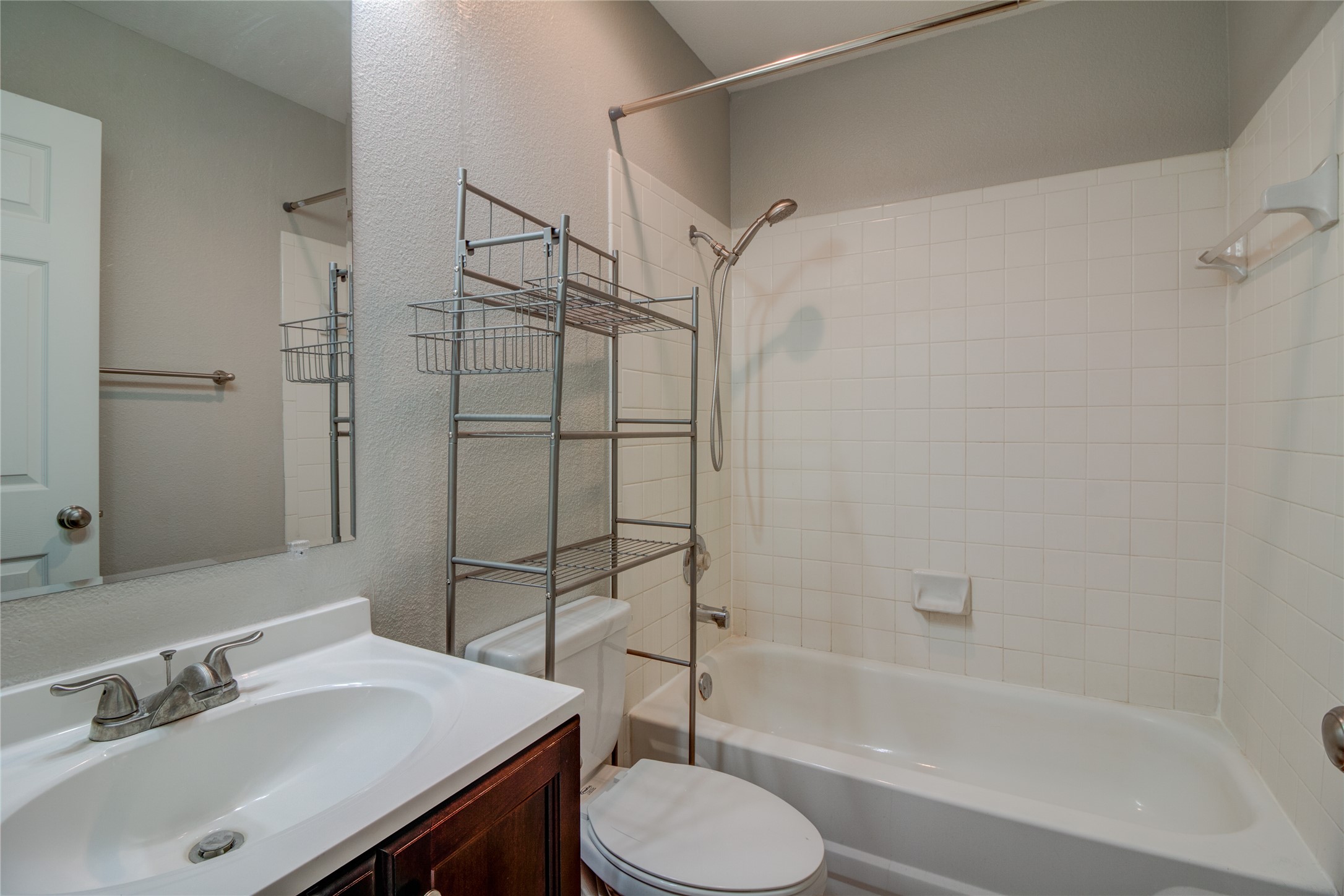 202 South College Street, Unit 9 Georgetown, TX 78626 - Photo 9 of 22 a bathroom with a sink toilet and shower