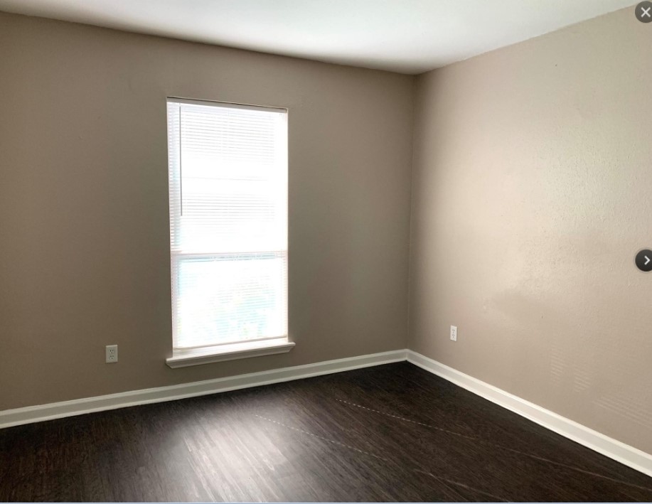 2200 Cypress Landing Road, Unit C12 Houston, TX 77090 - Photo 7 of 12 an empty room with wooden floor and windows