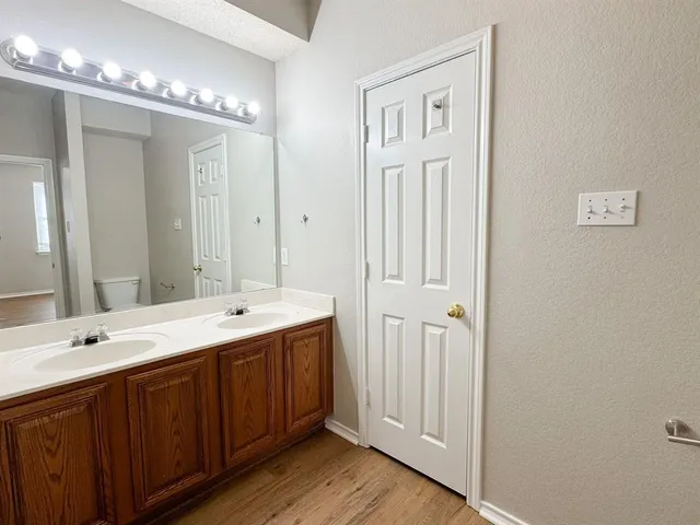 a spacious bathroom with a double vanity sink and a mirror