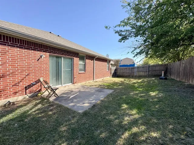 a view of a backyard with a large tree