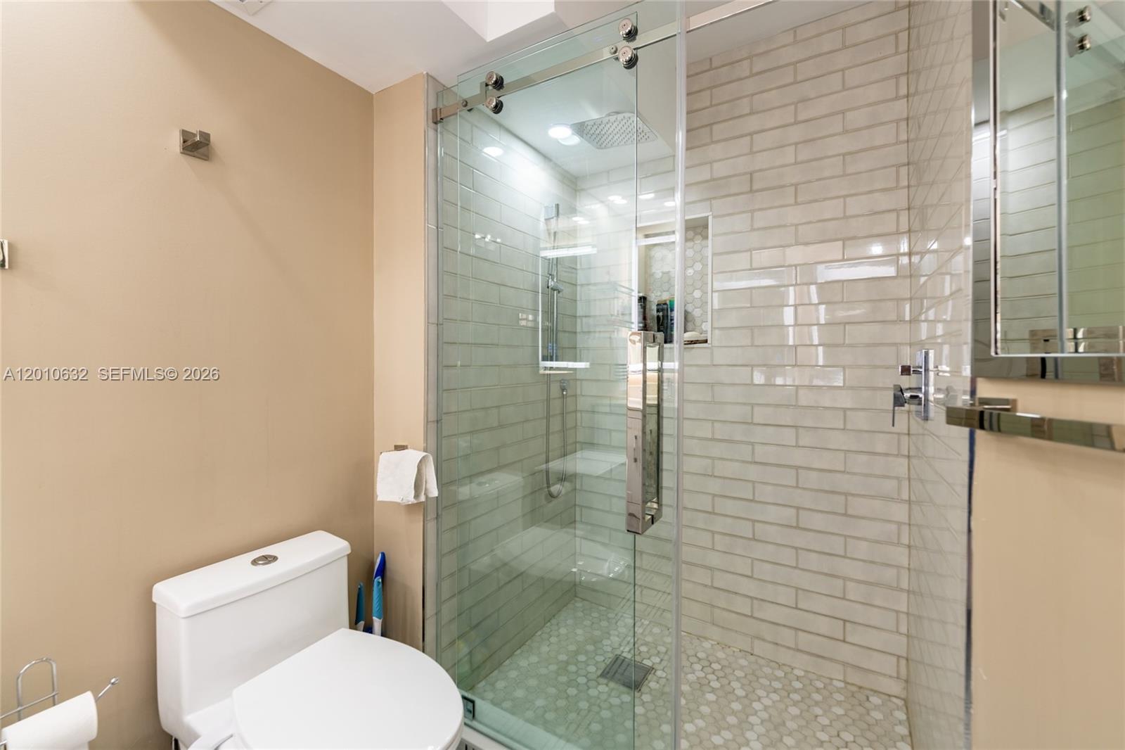 2639 North Riverside Drive, Unit 501 Pompano Beach, FL 33062 - Photo 20 of 39 a bathroom with a toilet and shower
