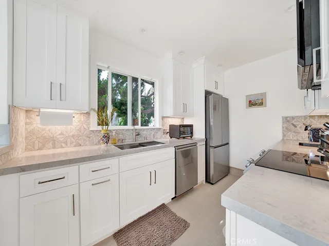 a kitchen with a sink stove and cabinets