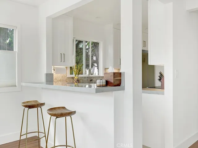 a view of a kitchen sink with granite countertop a window