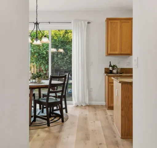 a kitchen with stainless steel appliances granite countertop a sink stove refrigerator and cabinets