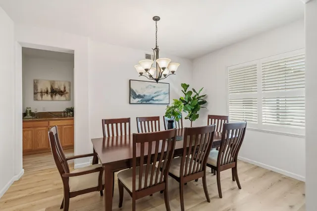 a view of a dining room with furniture wooden floor and chandelier