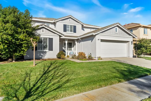 a front view of house with yard and green space