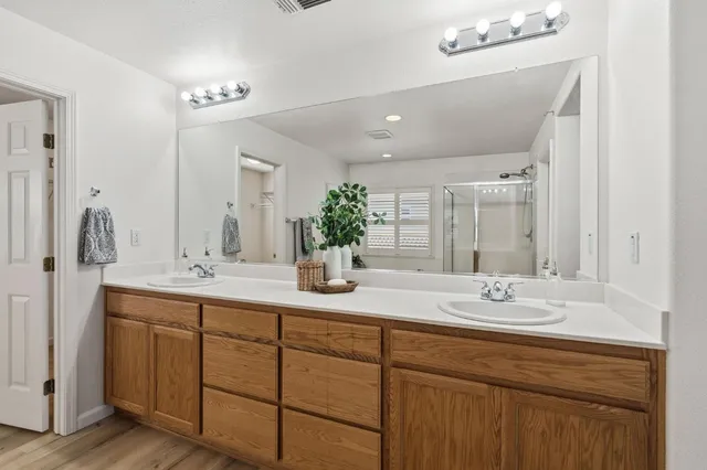 a bathroom with a tub sink and shower
