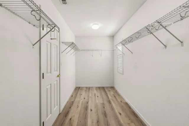 an empty room with a empty space and windows