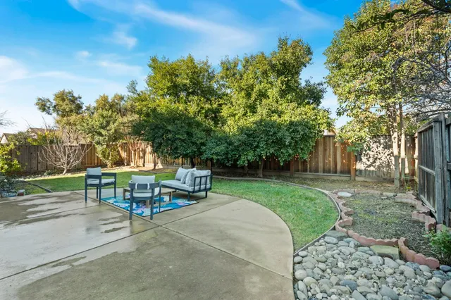 a view of a backyard with sitting area