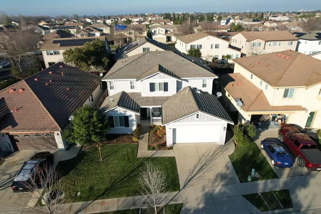 an aerial view of a house with a yard